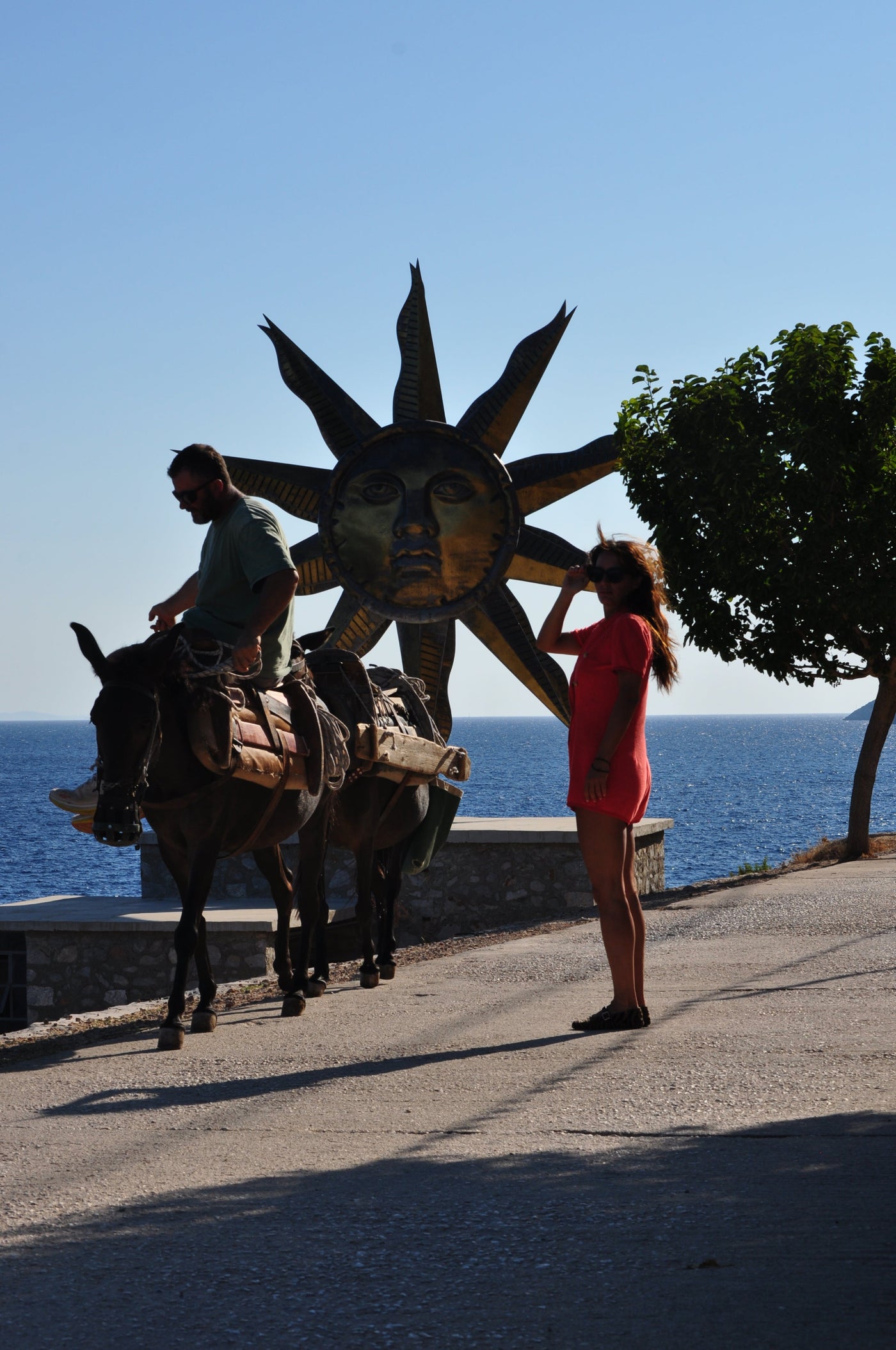 Eleanna Tabouri, Creative Director of Nevro Blazer, infant of the Jeff Koons installation Apollo Sun in Hydra wearing the Bloody Mary Nevro Blazer Terry playsuit